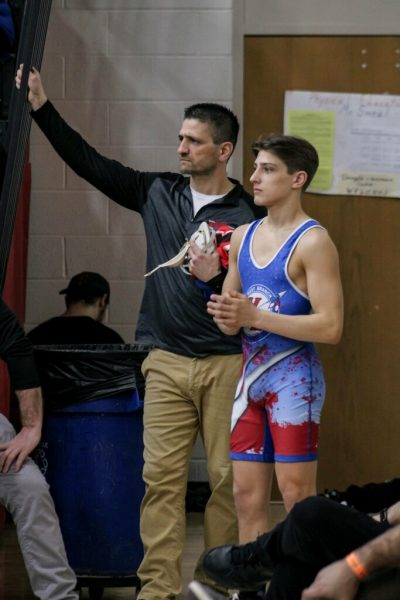 Landon Bainey chats with his dad, Jason Bainey, before his match. 