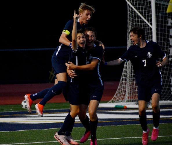 Cale McDowell celebrating with his teammates after scoring the game-winning goal