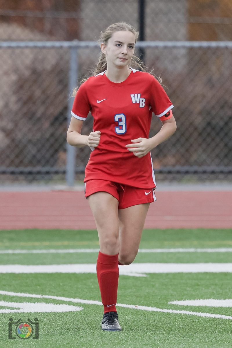 English running out in pre-game to prepare her defense to be strong against Bishop Carroll.