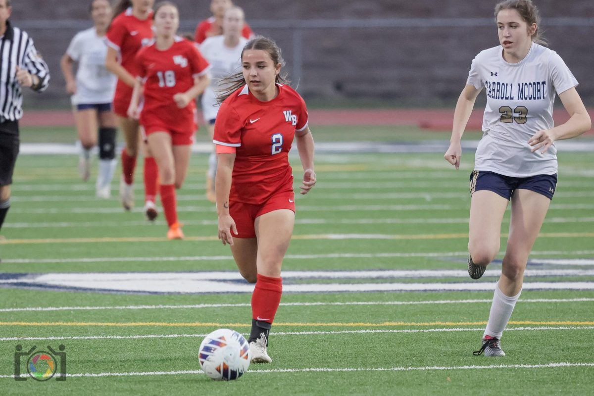 Fenush runs down the field hoping to find a teammate to assist with scoring a goal.