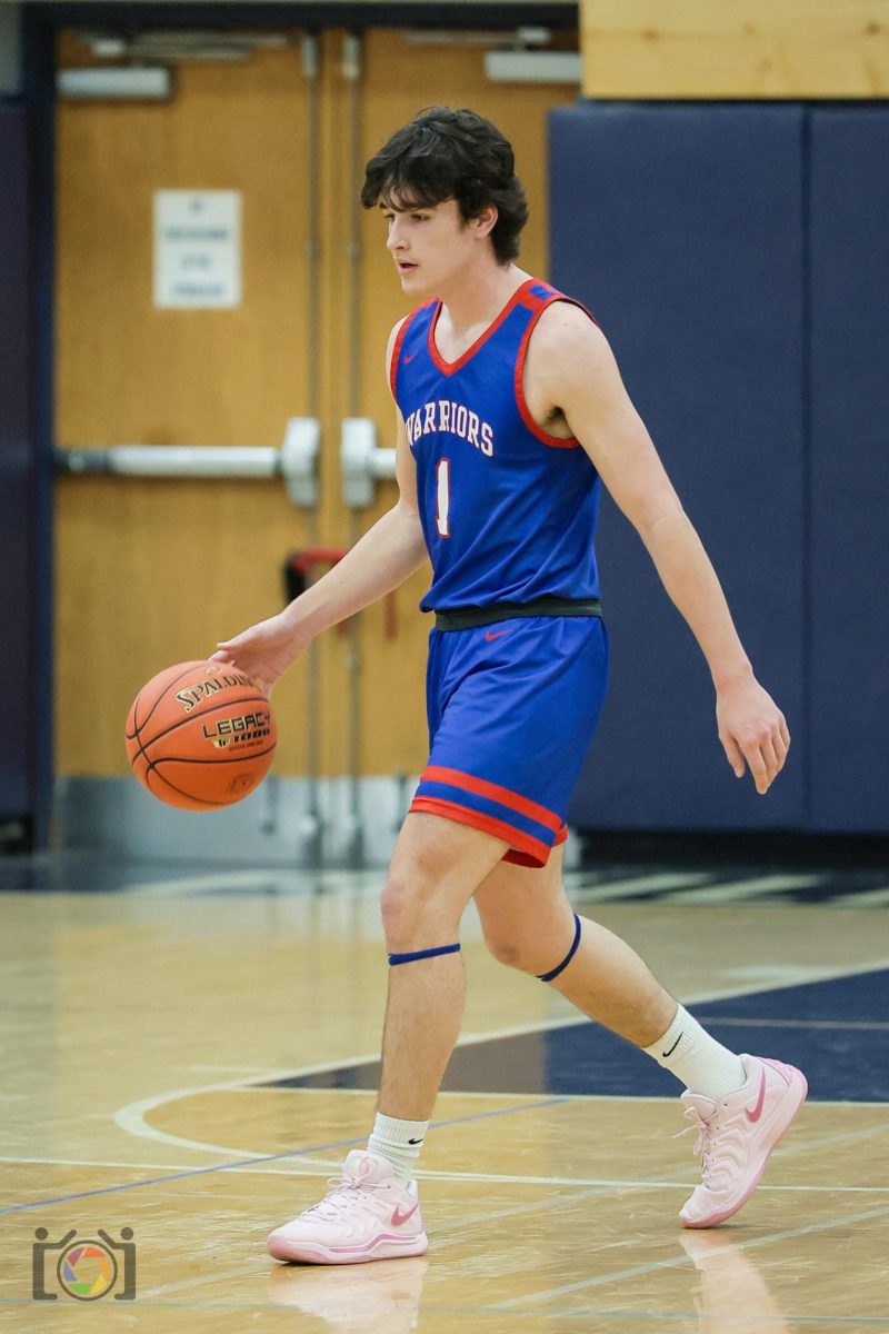  Lukas Colton dribbles up the court against St. Joe’s Academy.
