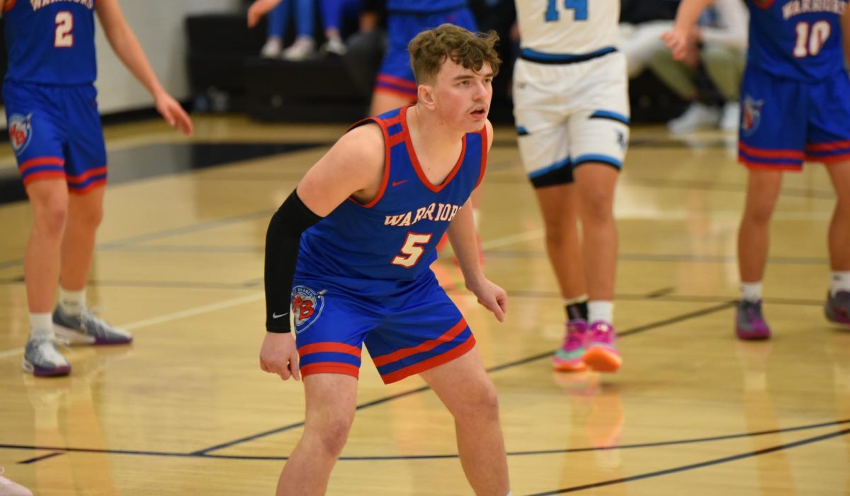 Logan Liptak locks in on his opponent during the Warriors’ game against River Valley. 