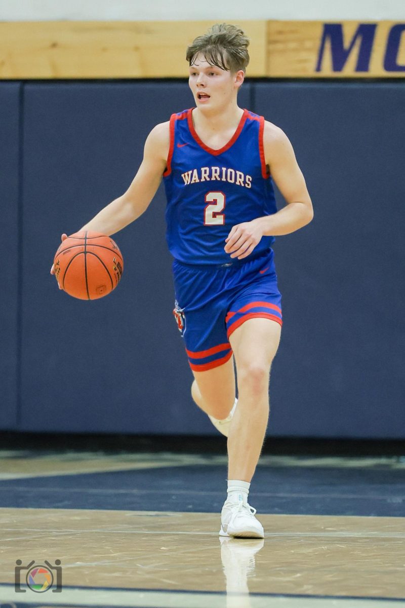 Joel Evans dribbling the ball down the court during a game against St. Josephs.