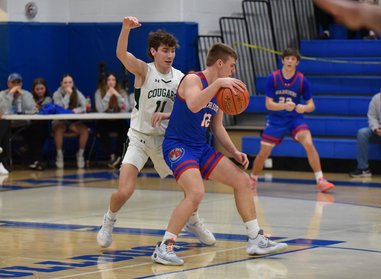 Owen Koleno spins around his defender to score the mid-range shot.