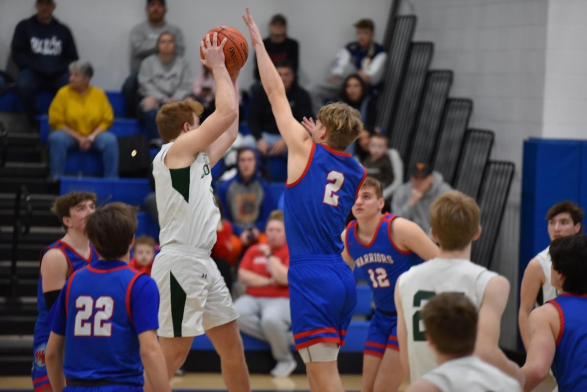 Joel Evans goes up for the tip-off against the North Star Cougars in the ICC playoffs.