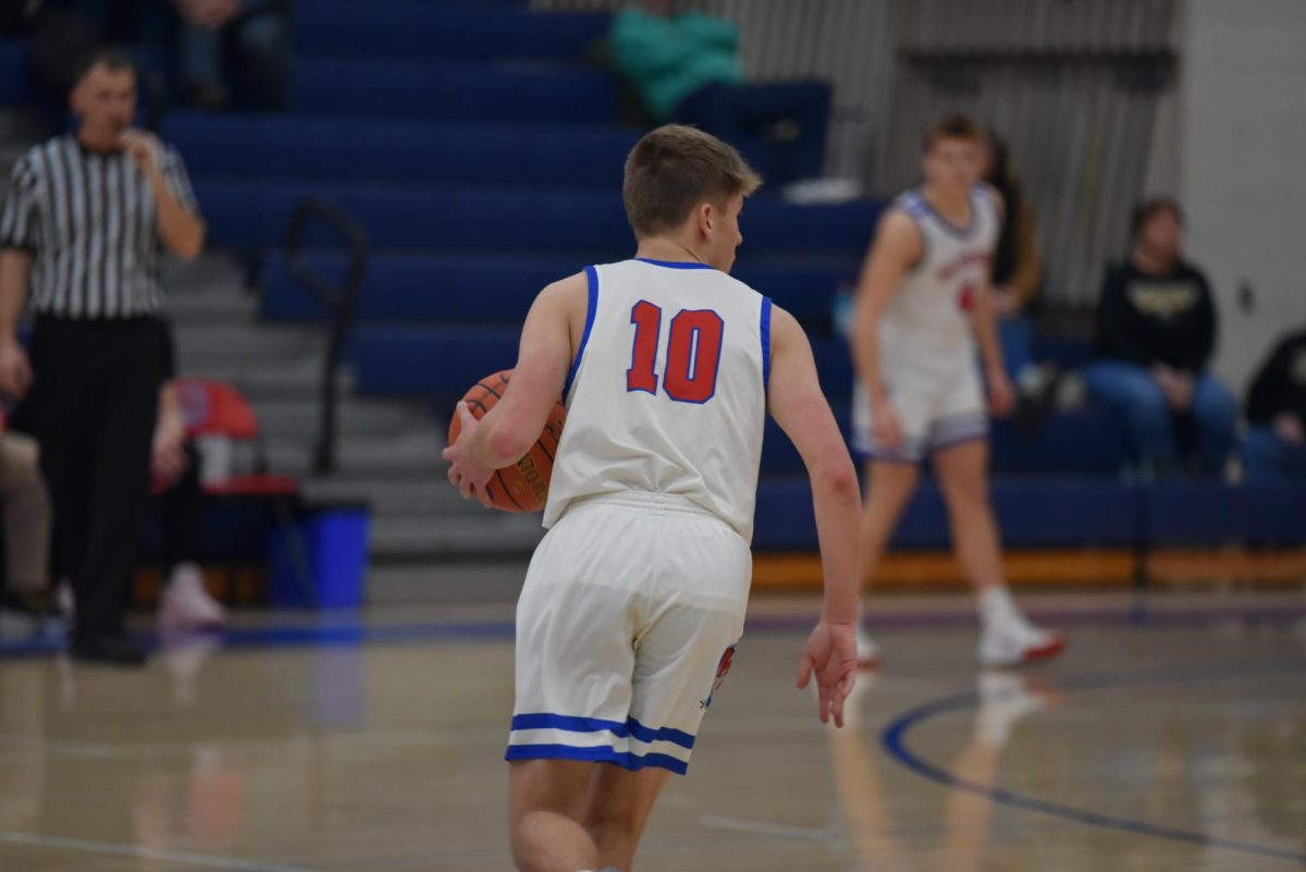 Coby Kephart driving the ball up the court against the Curwensville Golden Tide