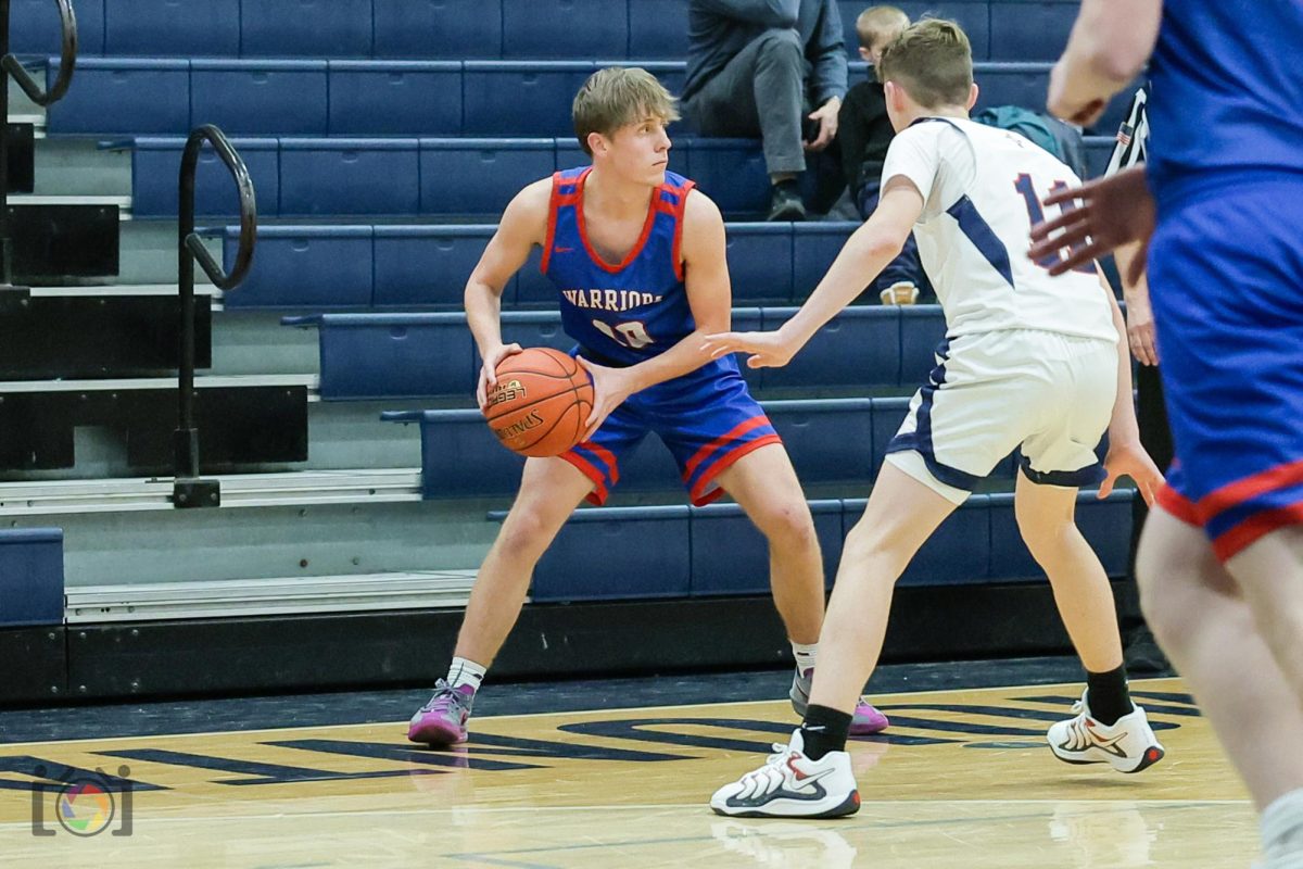 Coby Kephart keeps his focus and control of the ball as he faces tight defense from a Saint Joseph's Academy opponent.