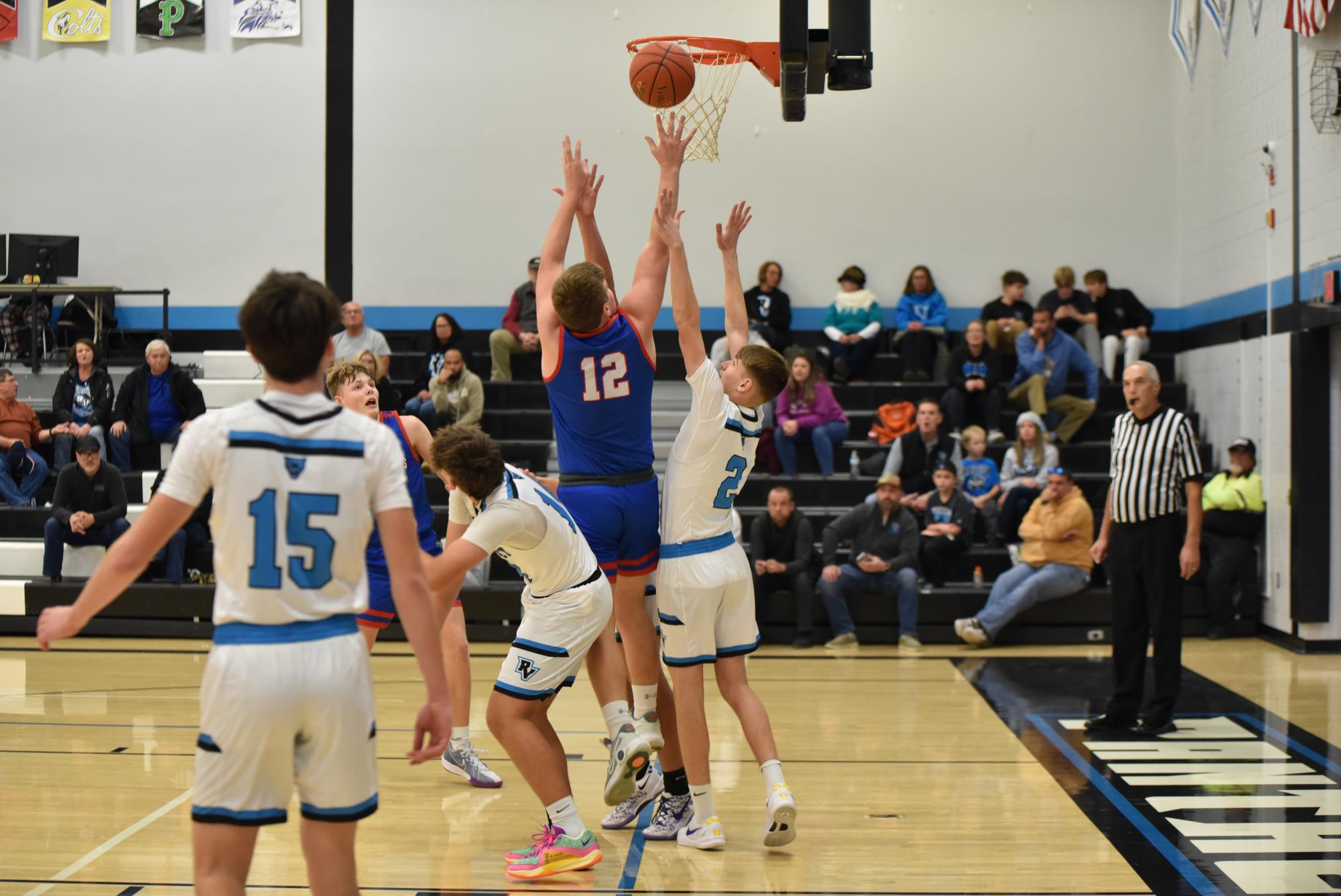 Owen Koleno takes it up for a layup over the defenders.