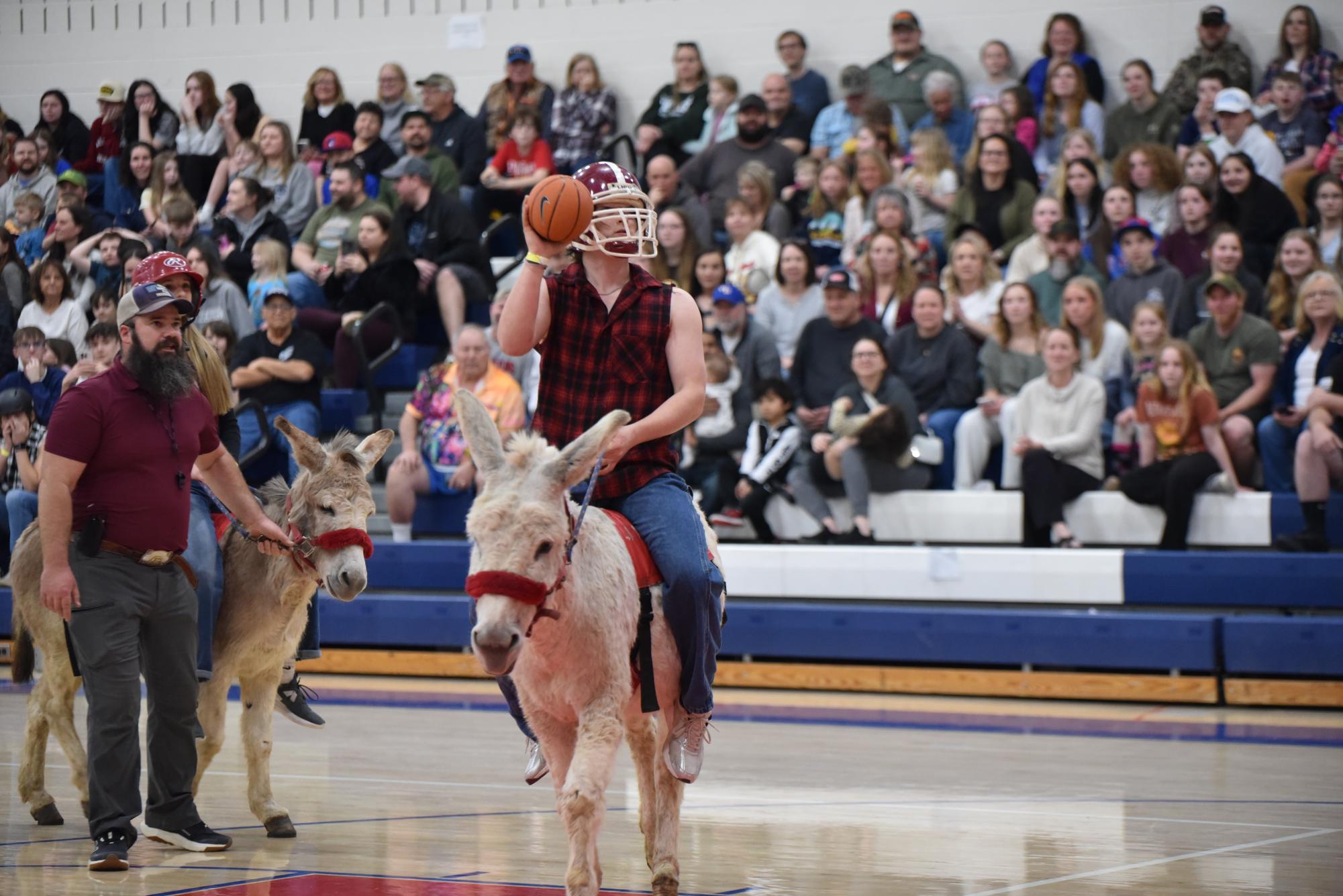 Nick Parks shooting from under the basket on his uncooperative donkey.