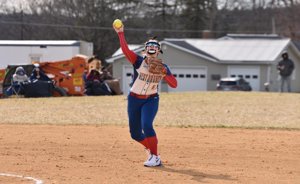 Senior third baseman Layla Thompson makes a throw to first base in the Warriors’ previous game against Bellwood.