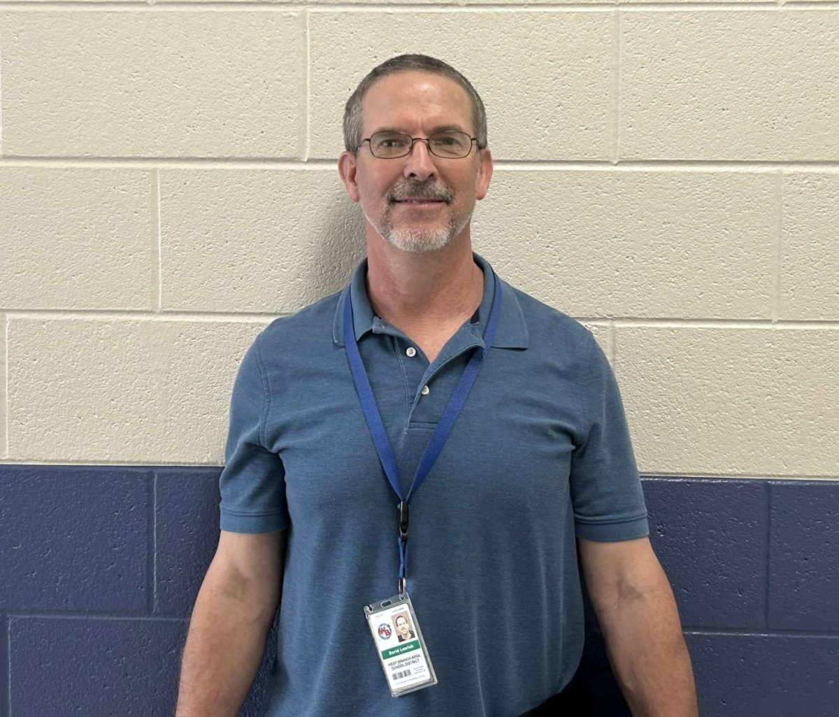 Mr. David Learish, long-time health and physical education teacher, shares a smile outside the gym where he’s inspired students for over two decades.