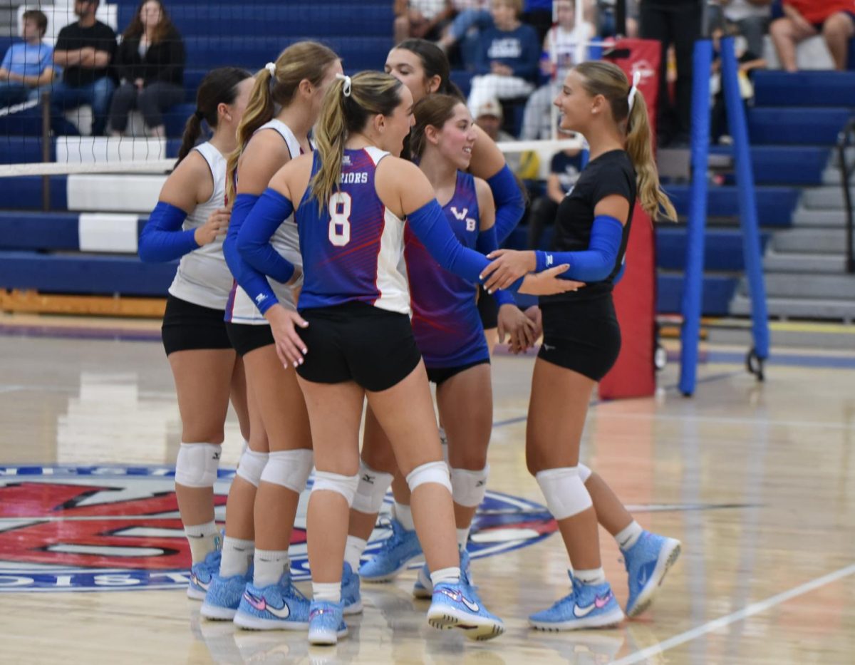 The Lady Warriors celebrate as they score a point against the Curwensville Golden Tide.