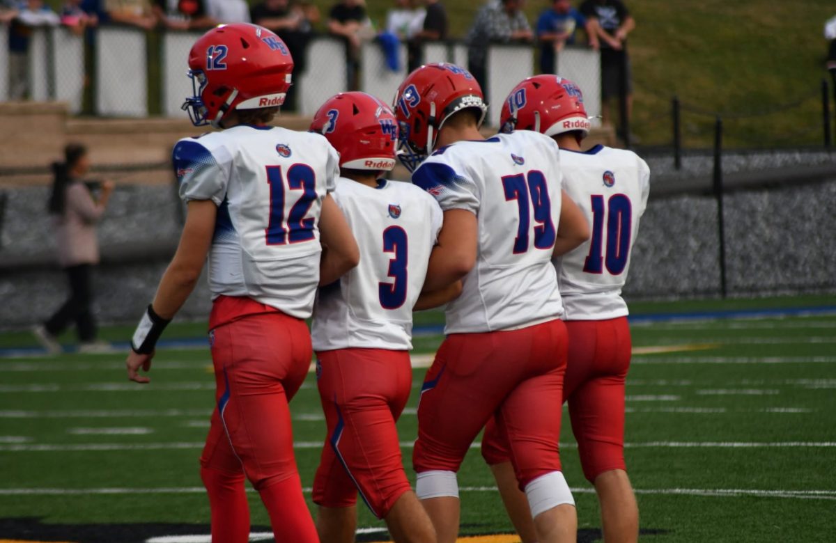 Warrior Captains Conner Danko (12), Gavin Dunlap (3), Coby Kephart (10), and Payton McCloskey (79) walk out to midfield.