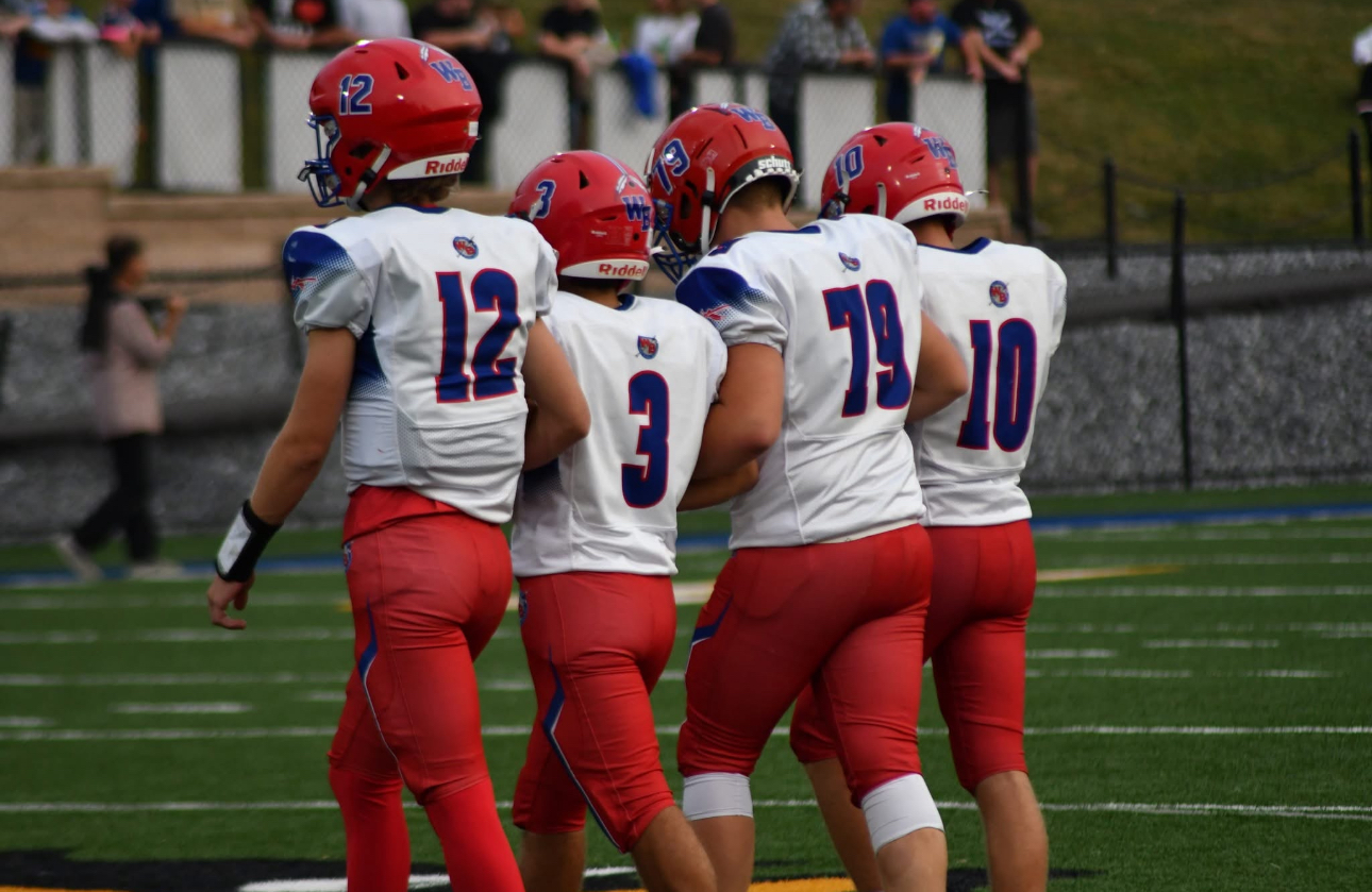 Warrior Captains Conner Danko (12), Gavin Dunlap (3), Coby Kephart (10), and Payton McCloskey (79) walk out to midfield.