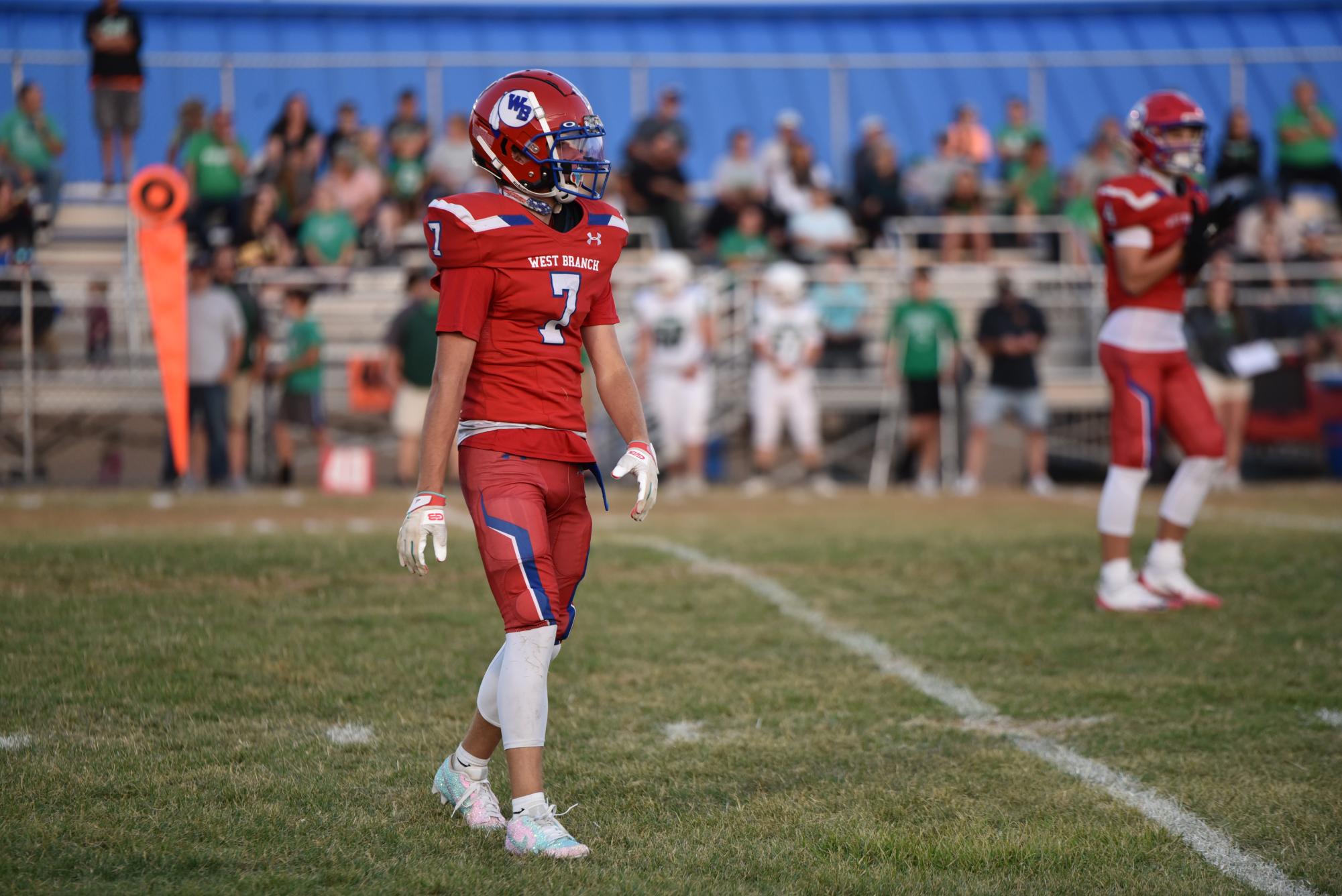 Easton Emigh waits for the play while showing off his all-red outfit and sparkling cleats.