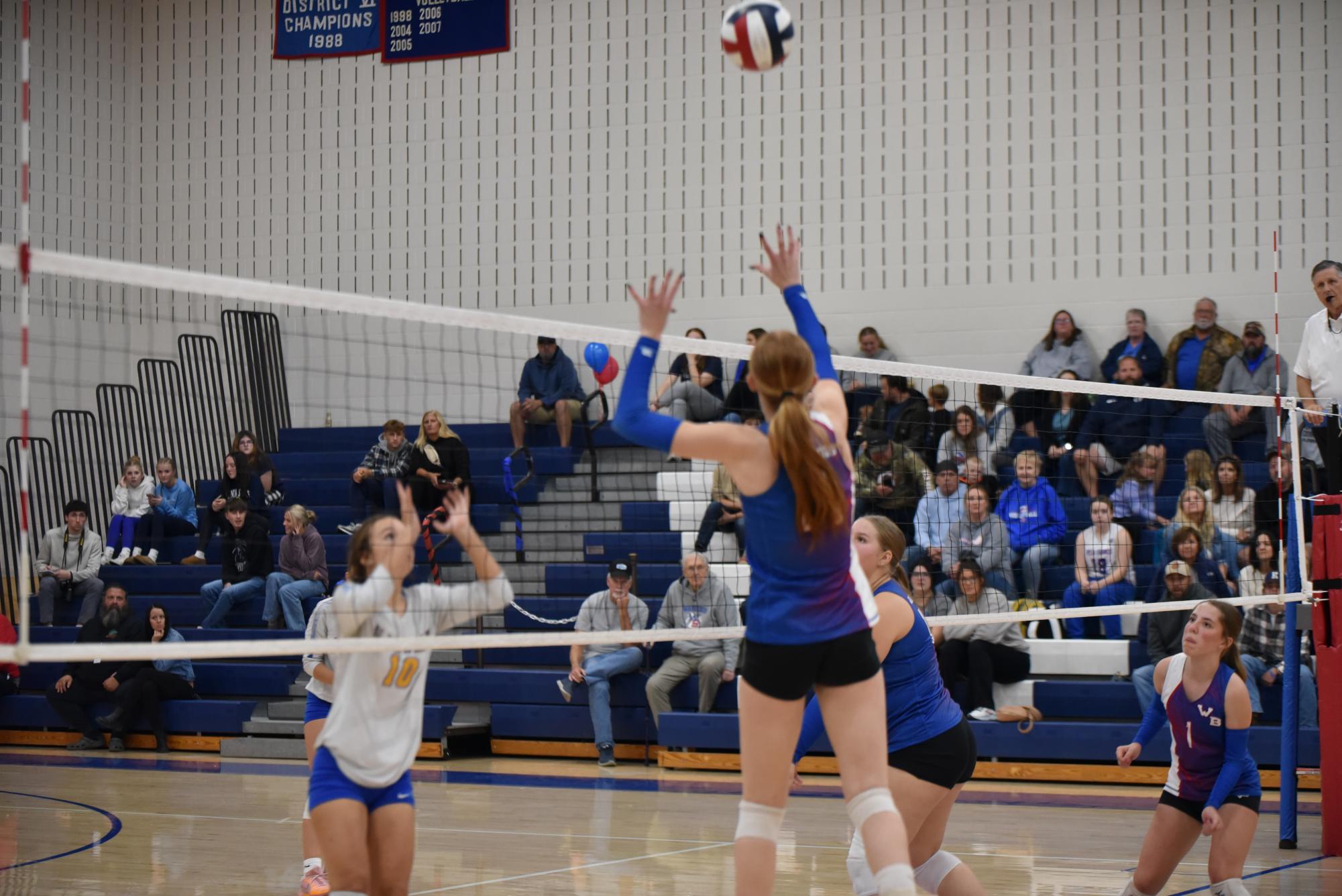 Lexie Mulhollem gets ready to spike the volleyball in the gap of Glendale defenders.