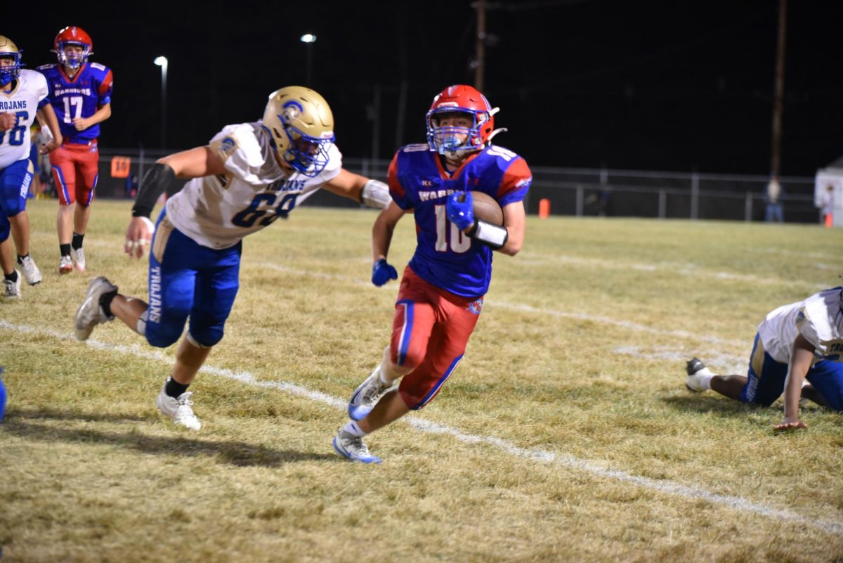 Coby Kephart runs the ball against the Mount Union Trojans to get yardage for the Warriors