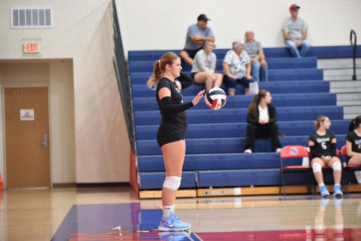 Koleno eyes up the court as she is getting ready to serve.
