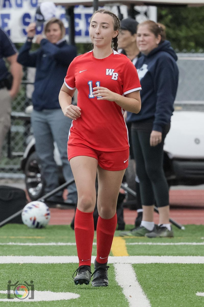 Ashley Causer runs out onto the field during the announcement of the starting lineups.
