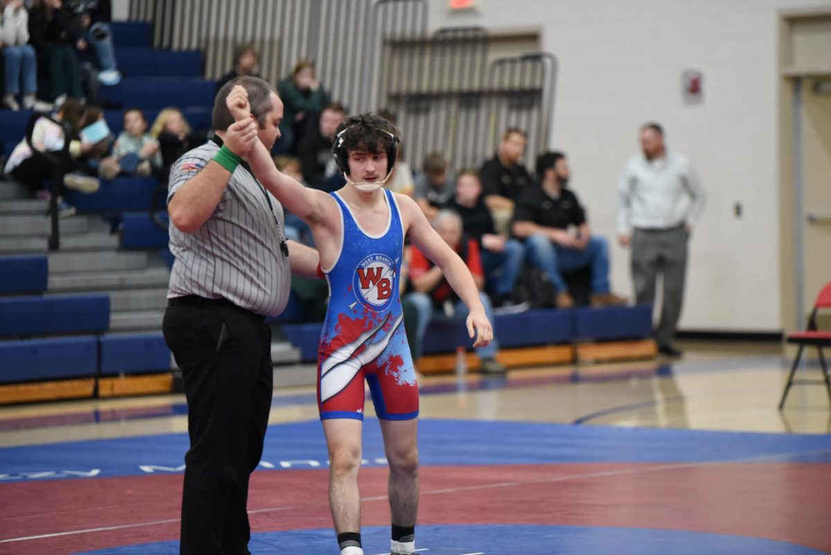 Bryce English get his hand raised after pinning his opponent to help his team in the quarterfinal D-6 match-up.  