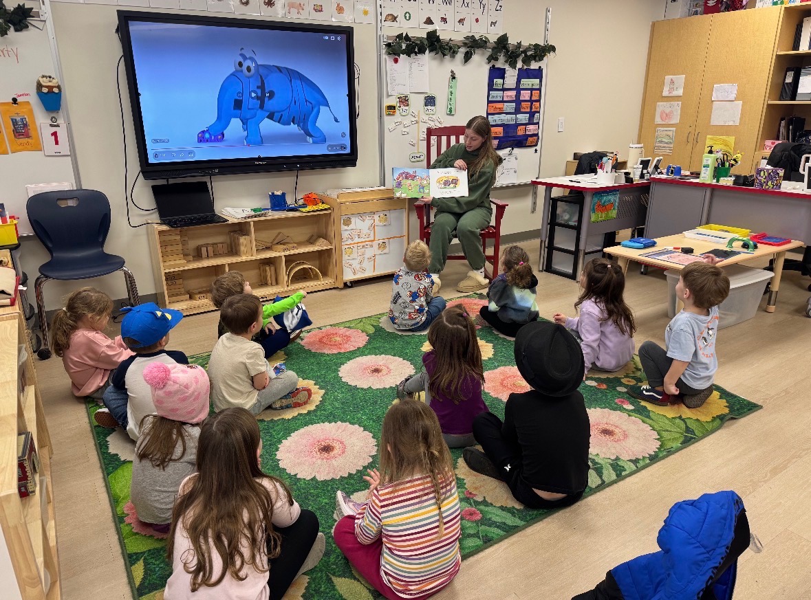Elementary students listen to an inspirational book reading by high school senior Emma Petriskey.
