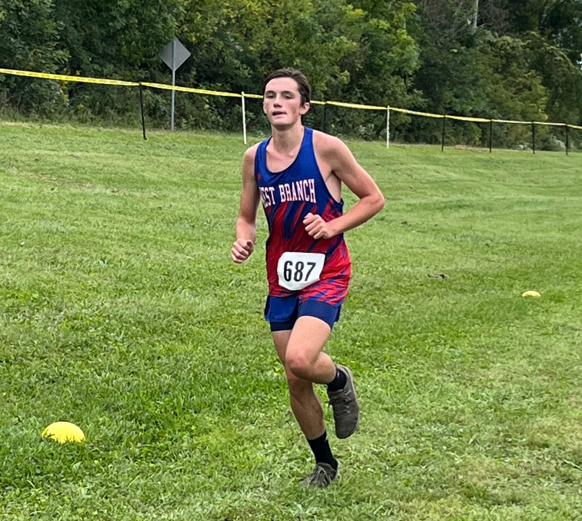 Carr continues down the course with a focused expression and steady stride.
